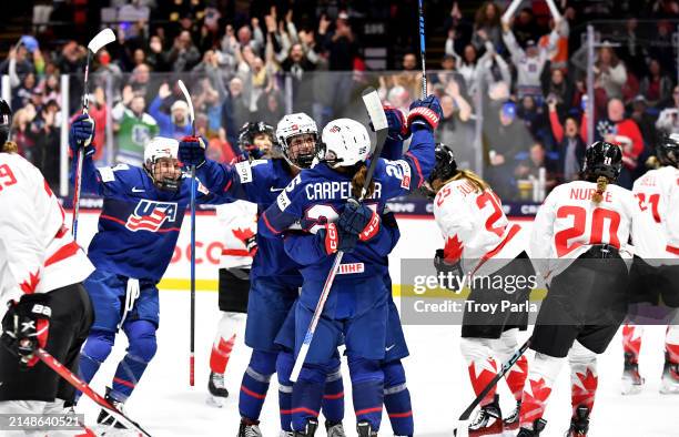 Caroline Harvey celebrates with Alex Carpenter of United States after Carpenter's goal in the second period against Canada during the 2024 IIHF...