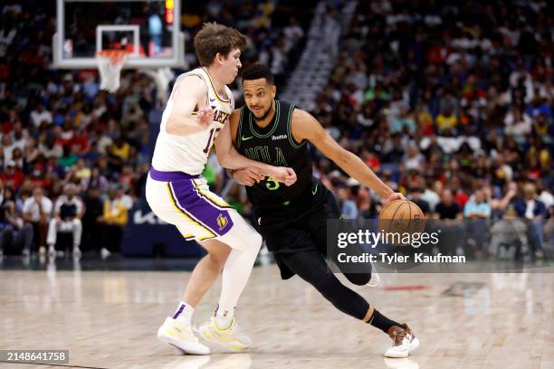 McCollum of the New Orleans Pelicans drives against Austin Reaves of the Los Angeles Lakers during the first half at Smoothie King Center on April...