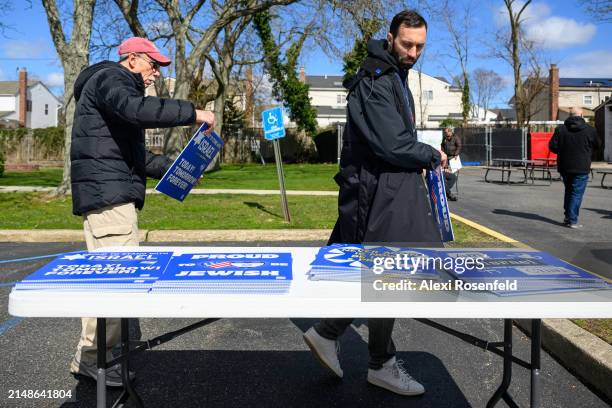 Daniel Lifshitz picks up posters at the six month "Bring Them Home Now" rally on April 7th, 2024 in Plainview, New York. Ahead of a trip to New York...