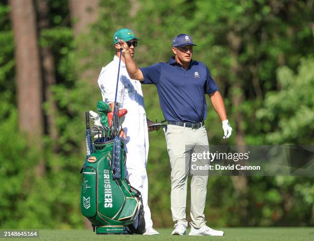 Bryson DeChambeau of The United States plays his second shot on the 11th hole during the final round of the 2024 Masters Tournament at Augusta...