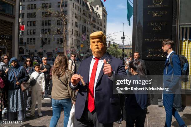 Person made up as former U.S. President Donald Trump stands outside of Trump Tower on April 14, 2024 in New York City. Trump is present in New York...