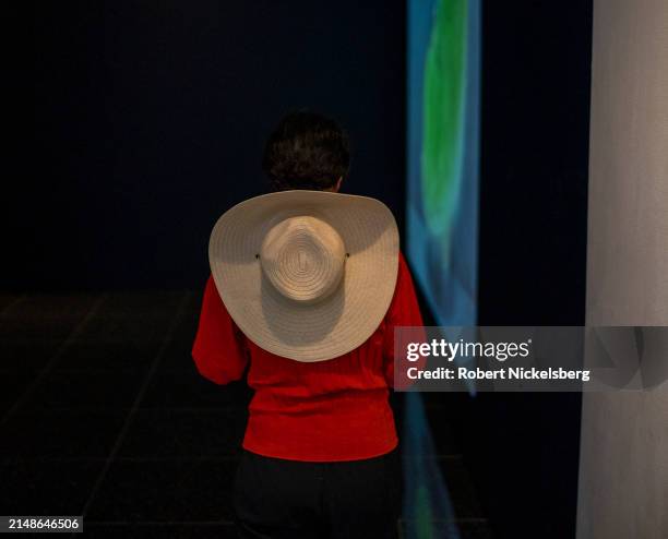Woman wearing a wide brimmed hat enters a theater to see a documentary movie "Intercepted" at the Museum of Modern Arts New Directors Festival April...