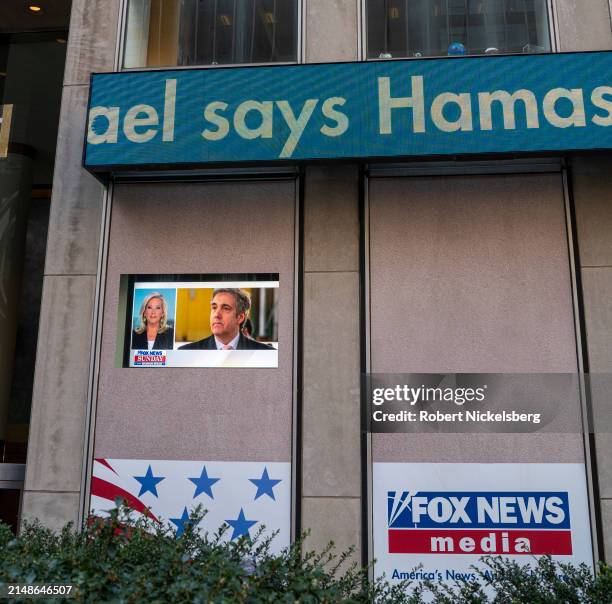 An electronic ticker moves across the Fox News headquarters with a picture of Michael Cohen, former attorney for former President Donald Trumps,...
