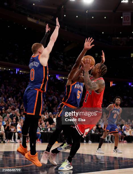 DeMar DeRozan of the Chicago Bulls heads for the net as Donte DiVincenzo and Precious Achiuwa of the New York Knicks defend in the final minute of...