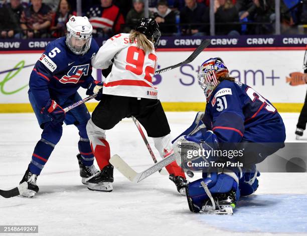 With Megan Keller of United States defending Danielle Serdachny of Canada finds the puck just prior to putting it past Aerin Frankel of United States...