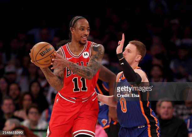 DeMar DeRozan of the Chicago Bulls tries to pass as Donte DiVincenzo of the New York Knicks defends during the first half at Madison Square Garden on...