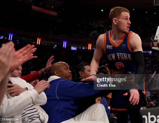 Donte DiVincenzo of the New York Knicks falls into Stephon Marbury as he chased a loose ball during the first half at Madison Square Garden on April...