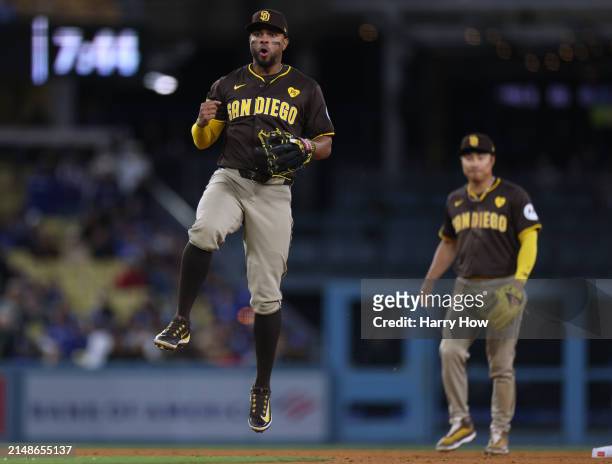 Xander Bogaerts of the San Diego Padres reacts to his throw to first base to complete a double play in front of Ha-Seong Kim, for a 6-3 win over the...