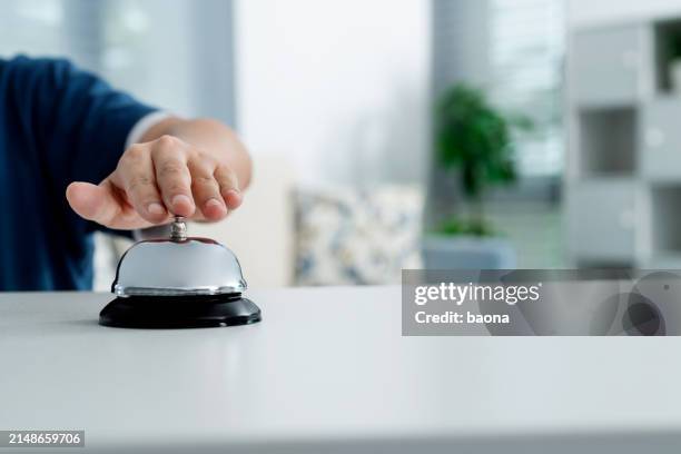 frau läutet eine dienstglocke - hotelpage stock-fotos und bilder