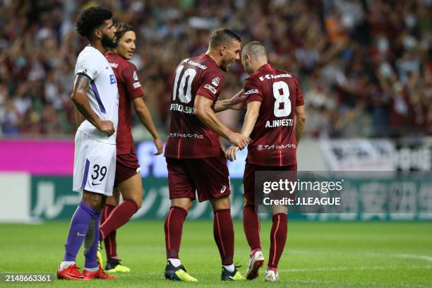 Andres Iniesta of Vissel Kobe celebrates with teammate Lukas Podolski after scoring the team's first goal during the J.League J1 match between Vissel...