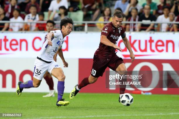 Lukas Podolski of Vissel Kobe controls the ball against Hayao Kawabe of Sanfrecce Hiroshima during the J.League J1 match between Vissel Kobe and...