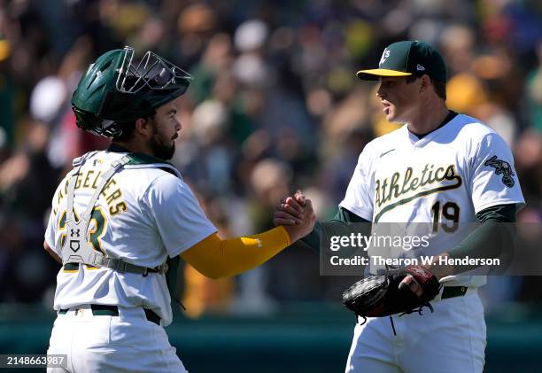 Shea Langeliers and Mason Miller of the Oakland Athletics celebrates defeating the Washington Nationals 7-6 on April 14, 2024 at the Oakland Coliseum...