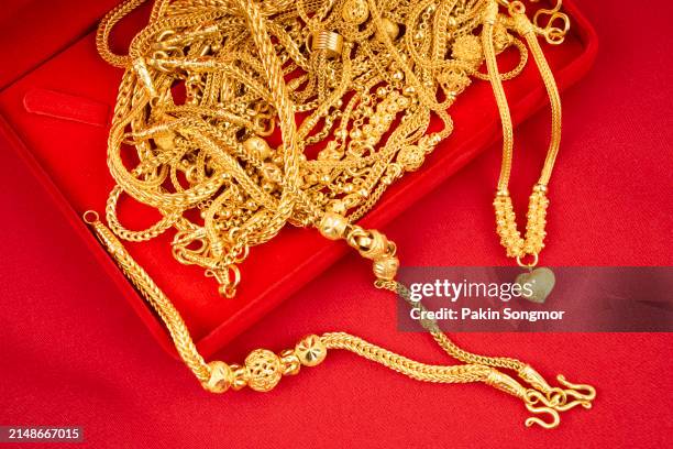 gold necklaces in a red velvet box on a red textile. - gold medal stock pictures, royalty-free photos & images