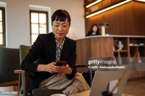 business traveler waiting in the lobby - hotel occupation stock pictures, royalty-free photos & images