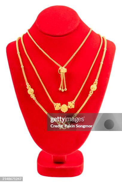 gold necklace on necklace display stand isolated on white background. - vintage embellishment stock pictures, royalty-free photos & images