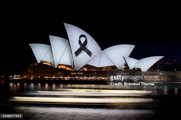 The Sydney Opera House is illuminated with a black ribbon in honour of the Bondi Junction victims on April 15, 2024 in Sydney, Australia. Six...