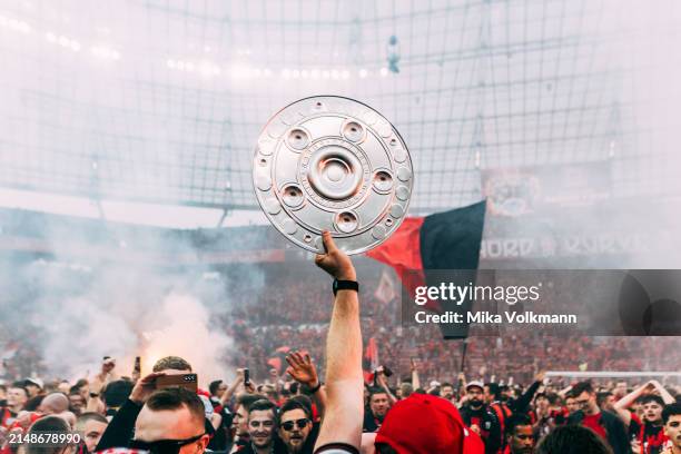 Fans of Leverkusen storm the field and celebrate the win of the championship during the Bundesliga match between Bayer 04 Leverkusen and SV Werder...