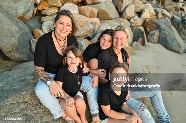 lesbian couple with their daughters - gay couple stock pictures, royalty-free photos & images