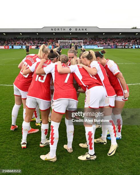 The Arsenal team form a huddle on the pitch prior to the Barclays Women's Super League match between Arsenal FC and Bristol City at Meadow Park on...