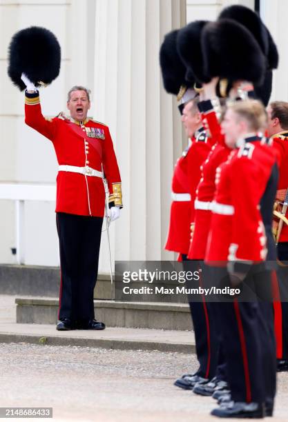 Soldiers of The Scots Guards raise their bearskins as they give three cheers to their colonel, Prince Edward, Duke of Kent as he departs after...