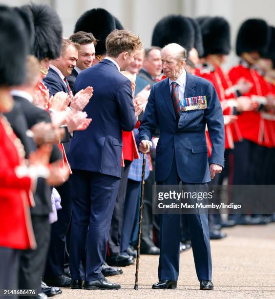 Prince Edward, Duke of Kent is applauded by soldiers of the Scots Guards and association veterans as he departs after attending the Scots Guards...