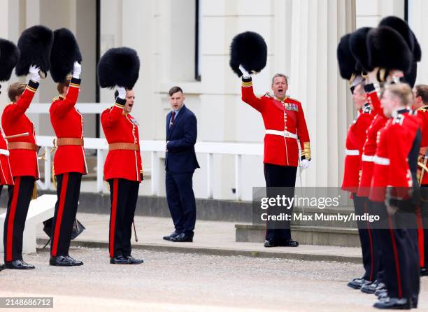 Soldiers of The Scots Guards raise their bearskins as they give three cheers to their colonel, Prince Edward, Duke of Kent as he departs after...