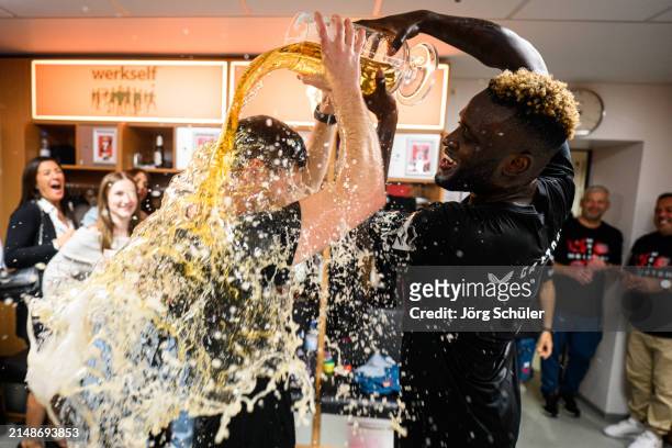 Headcoach Xabi Alonso of Leverkusen getting a beer shower by Victor Boniface during the celebrations in the locker room after the Bundesliga match...