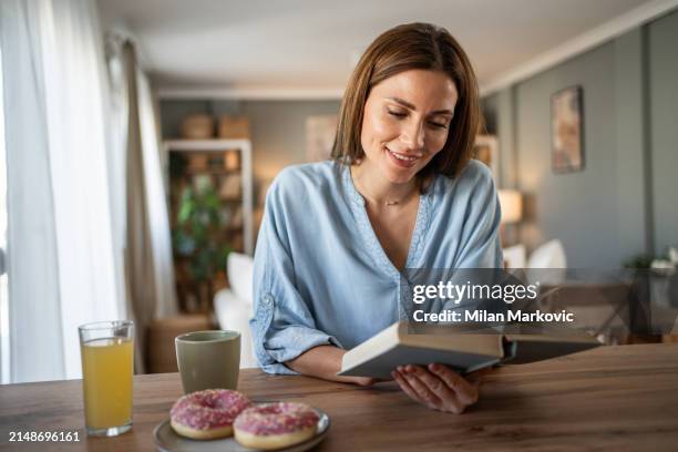 i love this quiet moment in the day with a good book and enjoying a weekend morning - milan markovic stock pictures, royalty-free photos & images