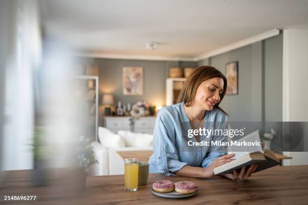 i love this quiet moment in the day with a good book and enjoying a weekend morning - milan markovic stock pictures, royalty-free photos & images