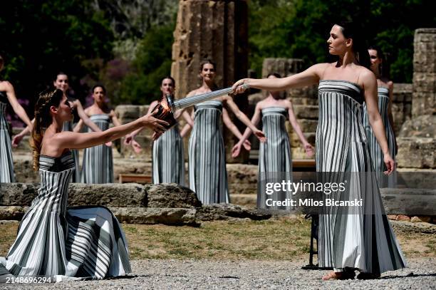 Greek actress Mary Mina, playing the role of the High Priestess, lights a cauldron during the flame lighting ceremony for the Paris 2024 Summer...