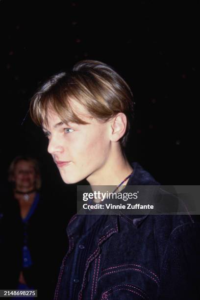 American actor Leonardo DiCaprio, wearing a black crew neck top beneath a black jacket with red stitching, attends the Hollywood premiere of 'What's...