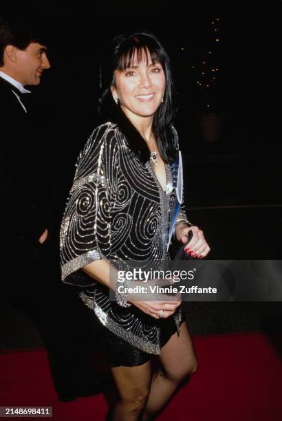 American actress Joyce DeWitt, wearing a black-and-silver outfit, attends a People's Choice Awards ceremony, United States, circa 1985.