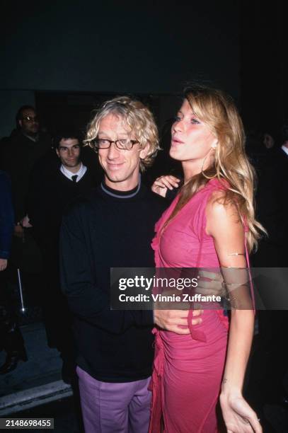 American comedian Andy Dick, wearing a black crew neck sweater with grey trim around the collar, and Brazilian fashion model Gisele Bundchen, who...