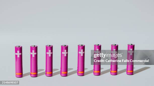 a row of purple aaa batteries - digital warning sign stock pictures, royalty-free photos & images