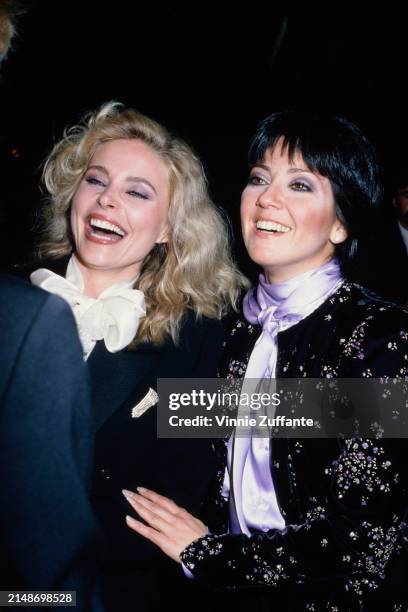 American actress Priscilla Barnes, wearing a black outfit with a white scarf, and American actress Joyce DeWitt, who wears a black outfit with floral...