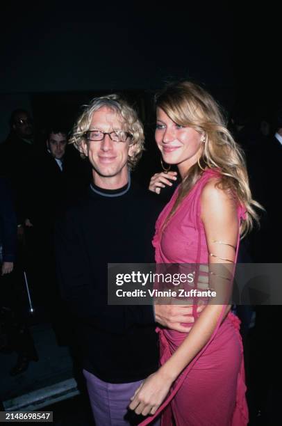 American comedian Andy Dick, wearing a black crew neck sweater with grey trim around the collar, and Brazilian fashion model Gisele Bundchen, who...