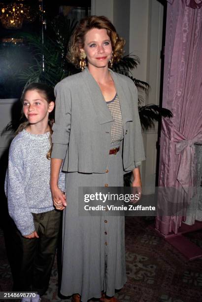 American actress Susan Dey, wearing a grey outfit and beaded drop earrings, and her daughter, Sara, who wears a grey crew-neck marl sweater, attend...