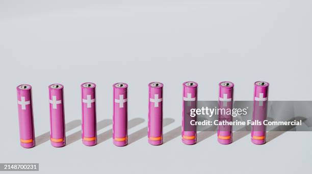 a row of purple aaa batteries - digital warning sign stock pictures, royalty-free photos & images