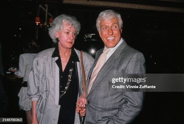 American actress and comedian Bea Arthur, wearing a black-and-white striped jacket over a black shirt, and American actor and comedian Dick Van...