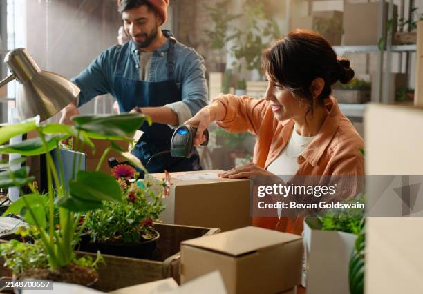 woman, scanner and barcode on boxes at startup with storage, sustainability and teamwork in workshop. people, partnership and laser for qr code, inventory and happy at small business in warehouse - labelling stock pictures, royalty-free photos & images
