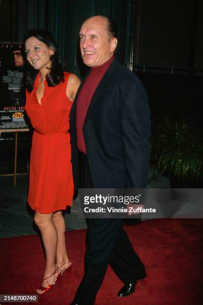 Argentine actress Luciana Pedraza, wearing a red dress, and American actor Robert Duvall, who wears a black suit with a red turtleneck sweater,...