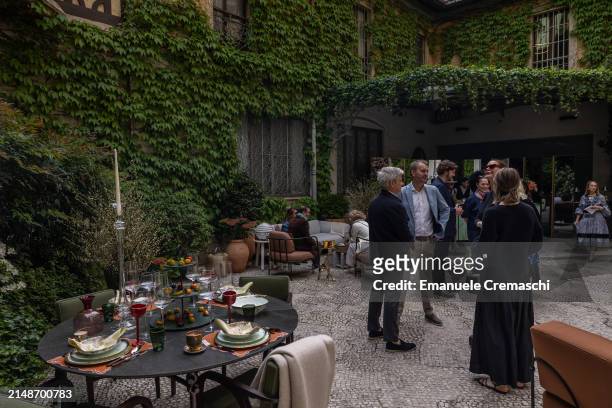 Guests chat after visiting the exhibition "L'Appartamento" by Artemest, located at Residenza Vignale, during the Milan Design Week 2024 on April 15,...