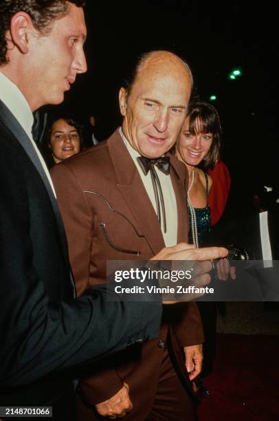 American actor Robert Duvall, wearing a brown suit over a white shirt with a bow tie, and American dancer Sharon Brophy , attend the 41st Primetime...