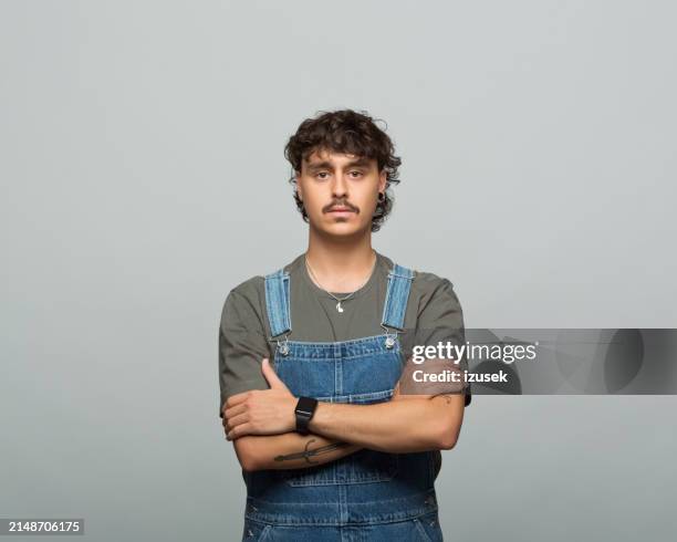 portrait of confident young man - bigote fotografías e imágenes de stock