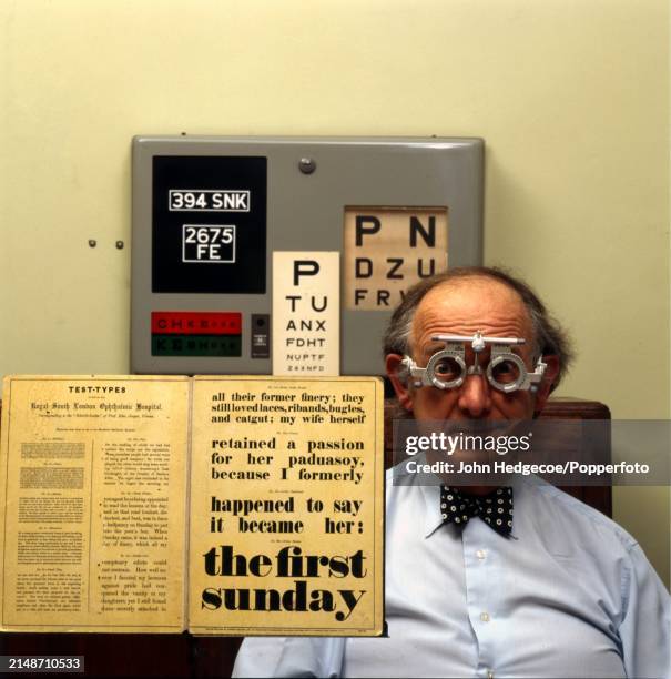 English eye surgeon John Keast-Butler posed with various eye testing charts and eye exam equipment, in England circa 1985. Keast-Butler was appointed...