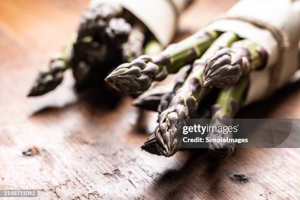 a bunch of fresh asparagus on an old rustic table. - slovakia country stock pictures, royalty-free photos & images