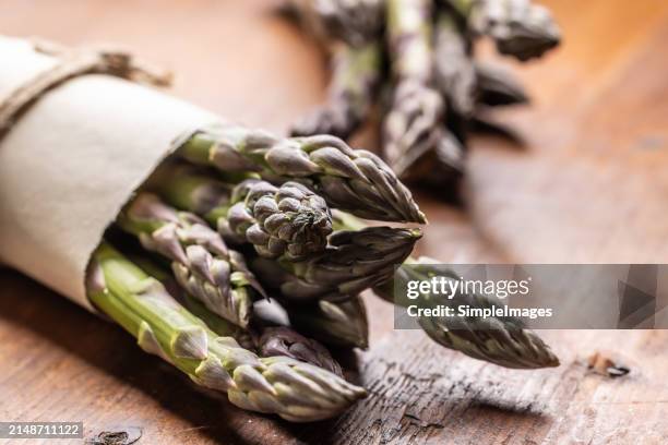 a bunch of fresh asparagus on an old rustic table. - slovakia country stock pictures, royalty-free photos & images