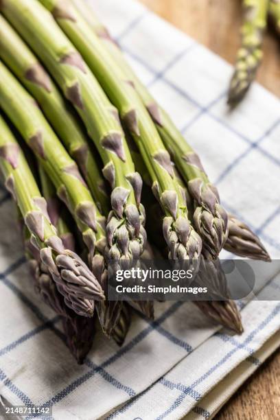 a bunch of fresh asparagus on an old rustic table. - slovakia country stock pictures, royalty-free photos & images