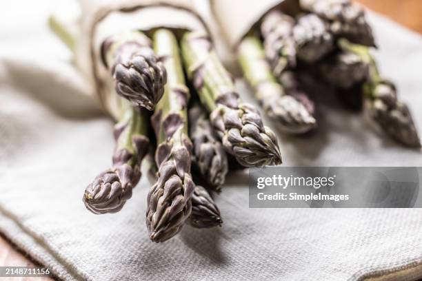 a bunch of fresh asparagus on an old rustic table. - slovakia country stock pictures, royalty-free photos & images