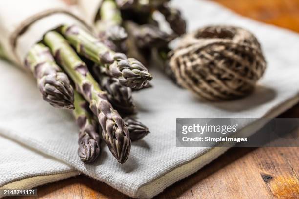 a bunch of fresh asparagus on an old rustic table. - slovakia country stock pictures, royalty-free photos & images
